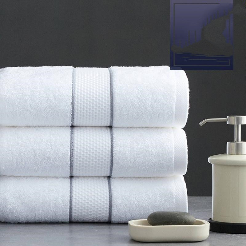 Atelier white cotton bath towel set including washcloth and hand towel styled in a luxury bathroom