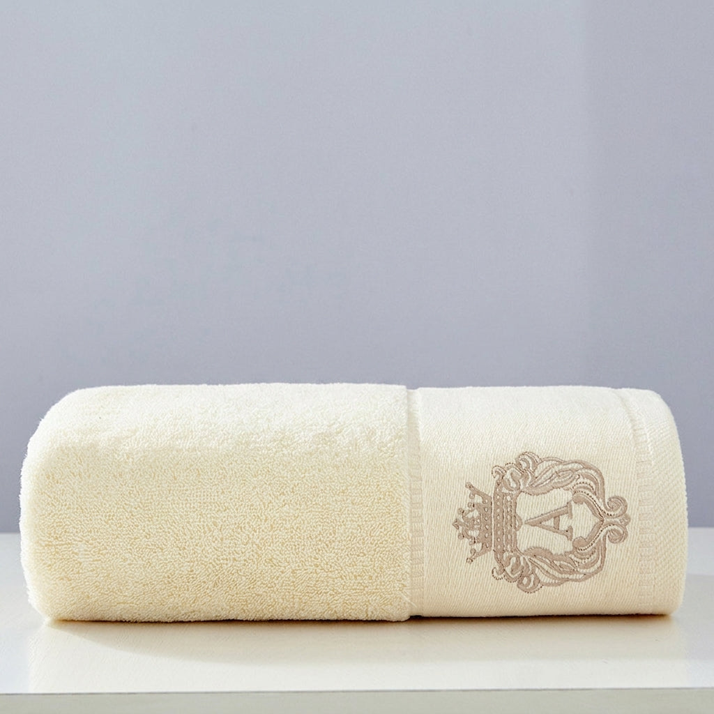 Austin luxury bath towel in beige – premium embroidered 100% cotton, folded neatly showing crown crest detail
