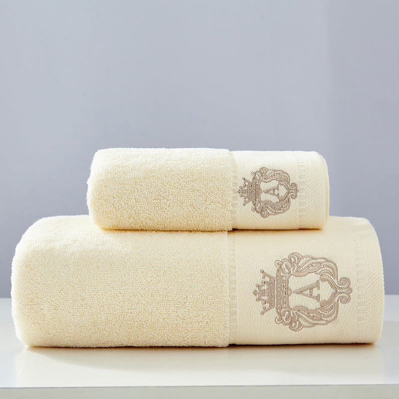 Austin luxury bath towels set in beige – premium embroidered 100% cotton, folded neatly showing crown crest detail
