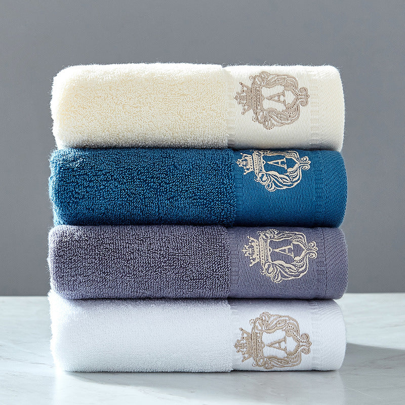 Austin luxury bath towels in all colors – beige, blue, grey, and white premium embroidered 100% cotton bath towels stacked together
