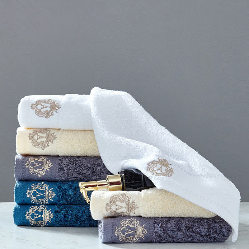 Austin luxury bath towel set in all colors – beige, blue, grey, and white premium embroidered 100% cotton bath towels stacked together
