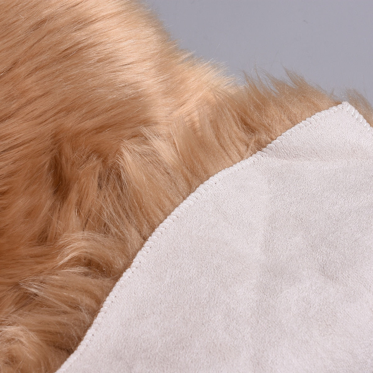 Birino faux sheepskin heart shaped rug folded to show caramel pile and suede backing, dual-layer construction detail