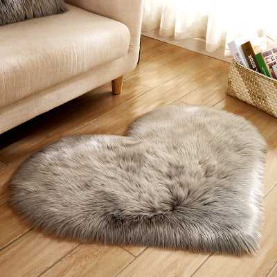 Birino faux sheepskin heart shaped rug in grey, fluffy bedroom rug on hardwood floor