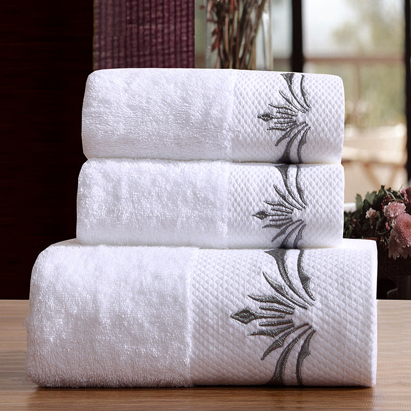 Dorie luxury bath towel set – white embroidered cotton towels stacked on wood surface