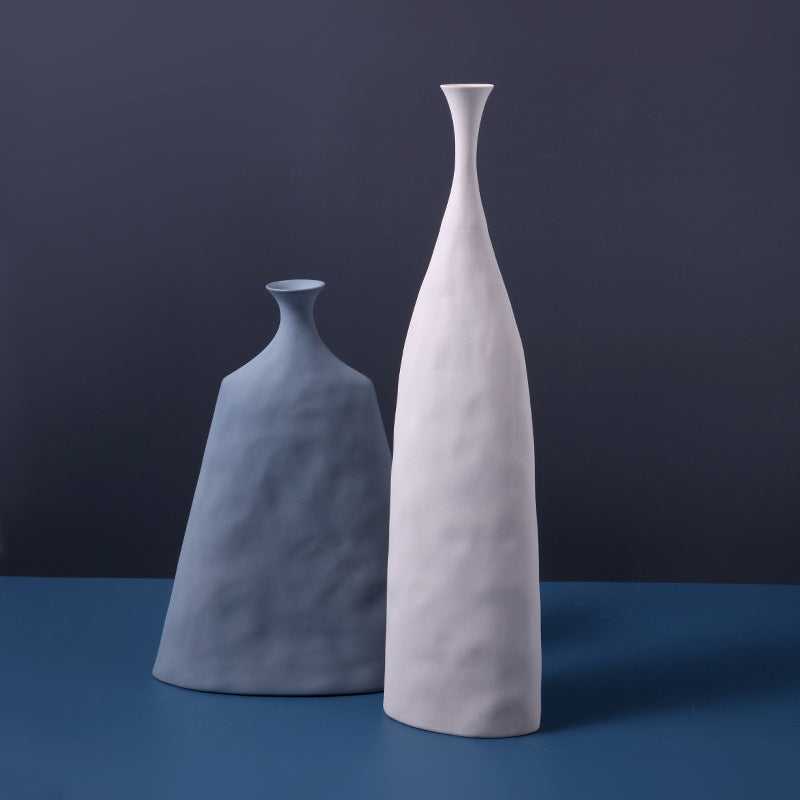 Hecho decorative ceramic vase in blue and white duo styled on dark blue surface – Nordic handmade home decor