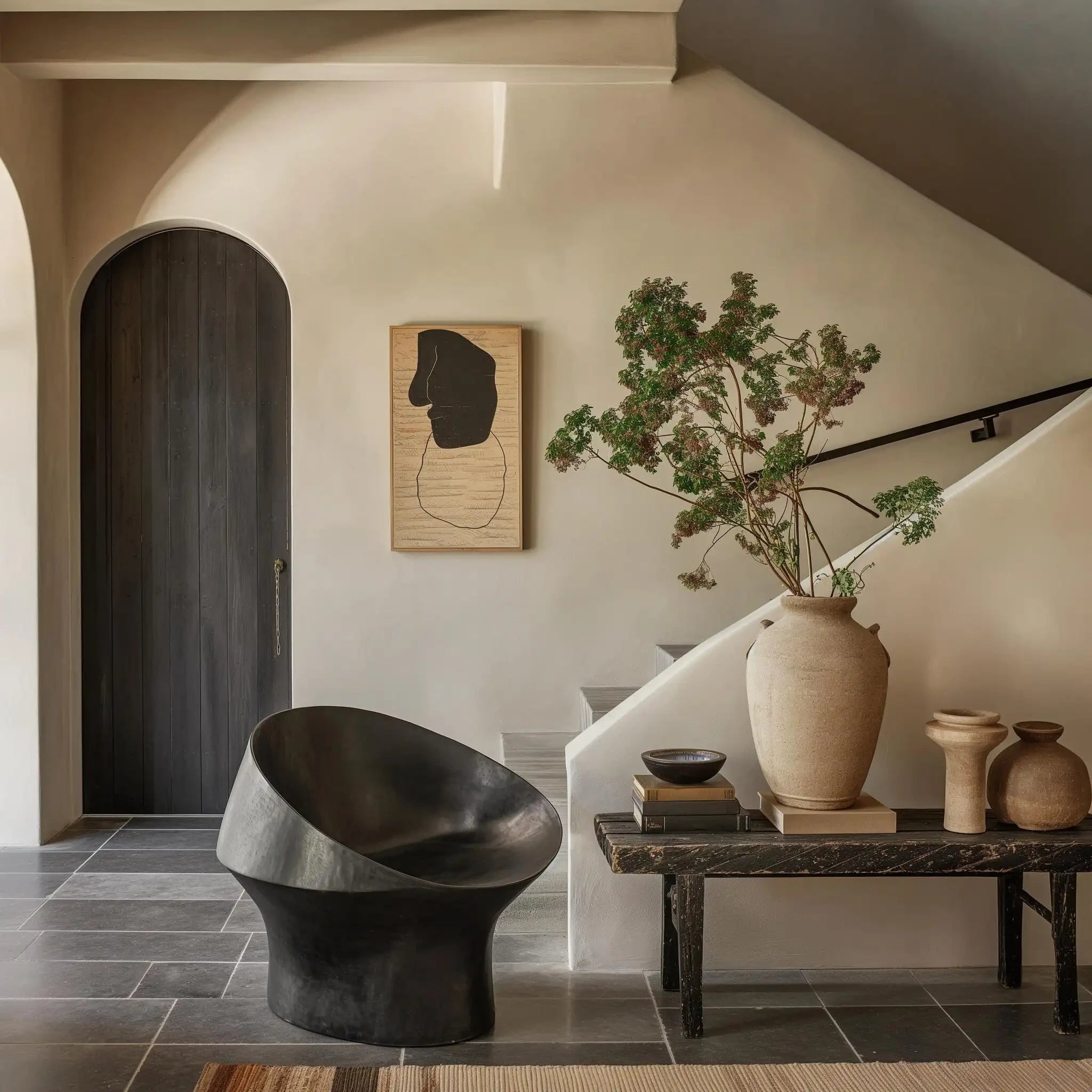 Elegant home living space with natural decor, sculptural furniture and ceramic vases
