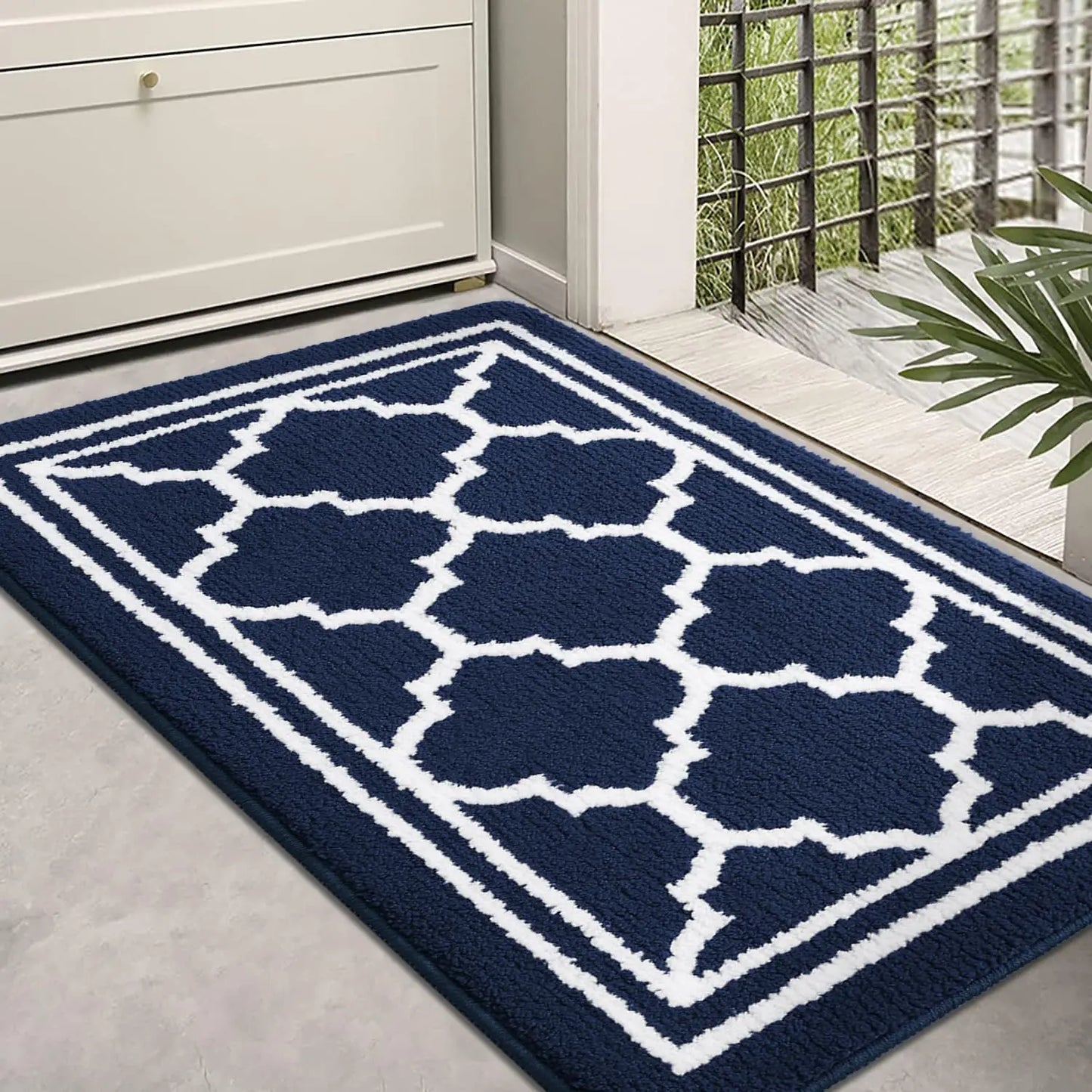 Navy blue Retika absorbent entrance rug in modern hallway interior