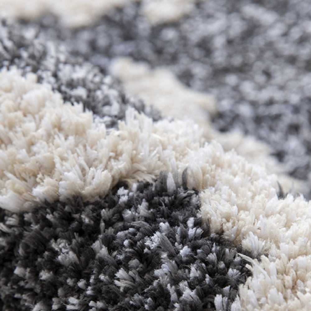 Extreme close-up of Schnauzer rug pile texture showing contrast between cream white and charcoal grey fibres