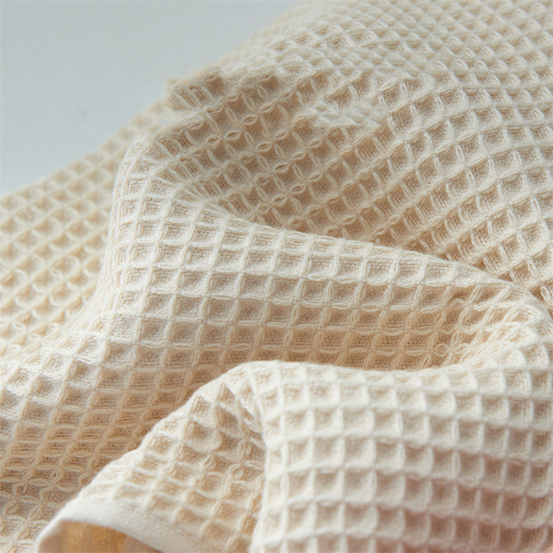 Close-up of Subako waffle weave cotton texture – honeycomb pattern soft absorbent bath towel in beige
